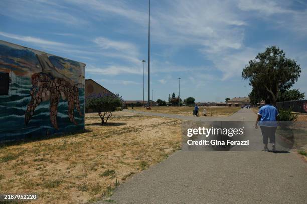 Incarcerated women walk the grounds at the Central California Women's Facility on June 18, 2024 in Chowchilla, California.
