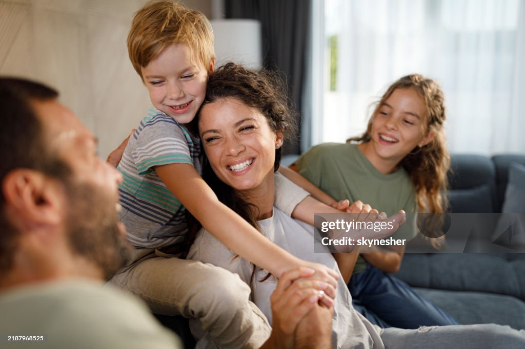 Cheerful family having fun while talking at home.