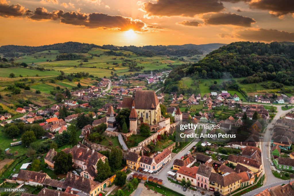 Aerial view of Biertan village with fortified church at sunset. Transylvania, Romania