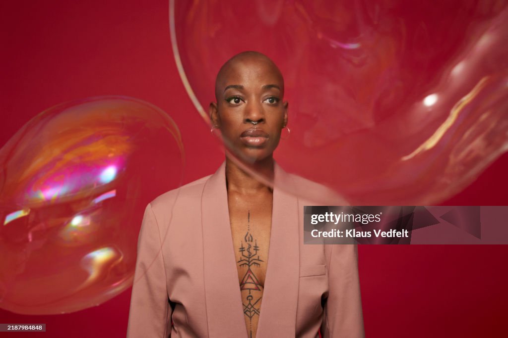 Non-binary person with phobia staring at bubbles