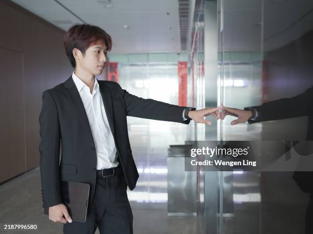 asian business man pressing the elevator button - pressing elevator button stock pictures, royalty-free photos & images