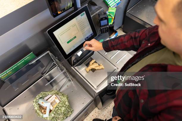 man at the self service checkouts - self service stock pictures, royalty-free photos & images