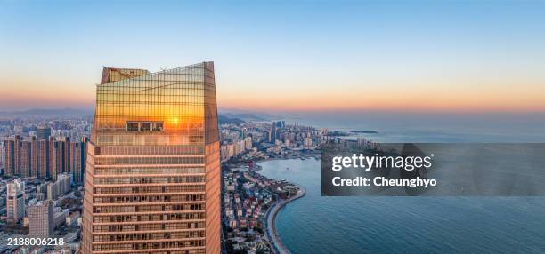 drone point view of the local landmark of qingdao cityscape at sunset - strand van qingdao stockfoto's en -beelden