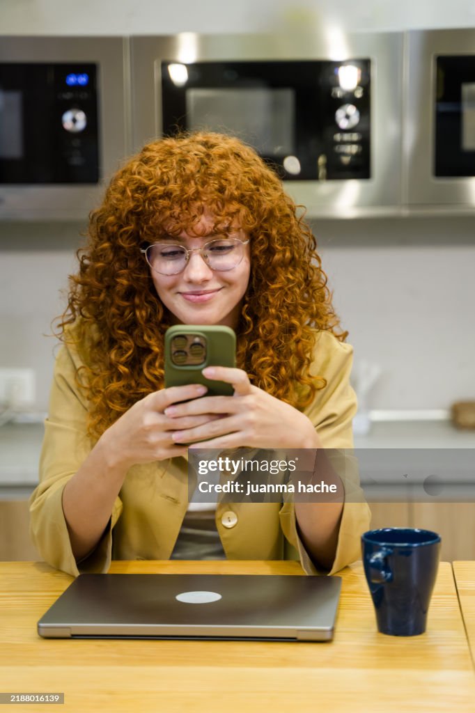Business woman using smartphone in office break room