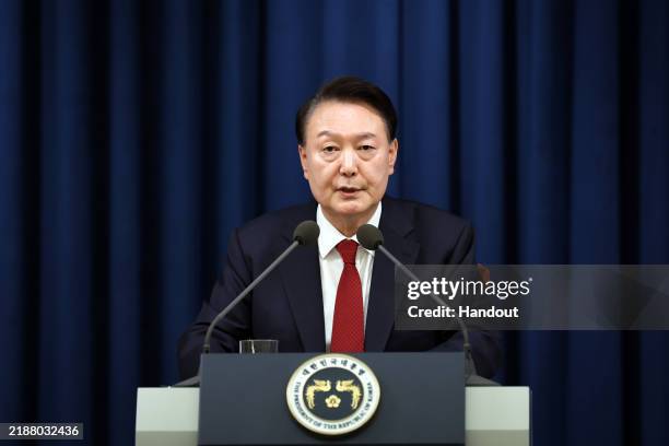 In this handout image provided by South Korean Presidential Office, South Korean President Yoon Suk-Yeol speaks during the declaration of emergency...