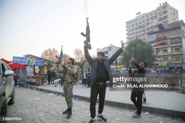 Armed rebels celebrate their advances in Hama, Syria, by firing shots into the air on December 6, 2024. Rebels led by HTS have intensified their...