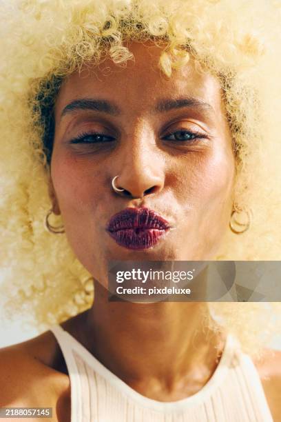 gen z multiracial woman with blonde afro pouting her lips. beauty and wellness concept. - pierced nose stock pictures, royalty-free photos & images