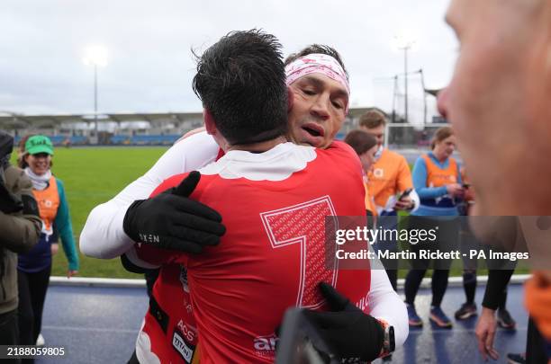 Kevin Sinfield embraces Mayor of Greater Manchester Andy Burnham after taking part in the Extra Mile event at the Etihad Campus in Manchester before...