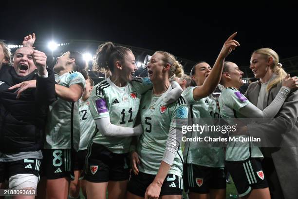 Hannah Cain and Rhiannon Roberts of Wales celebrate victory following the UEFA Women's EURO 2025 Play-Off Round Two Second Leg match between Republic...