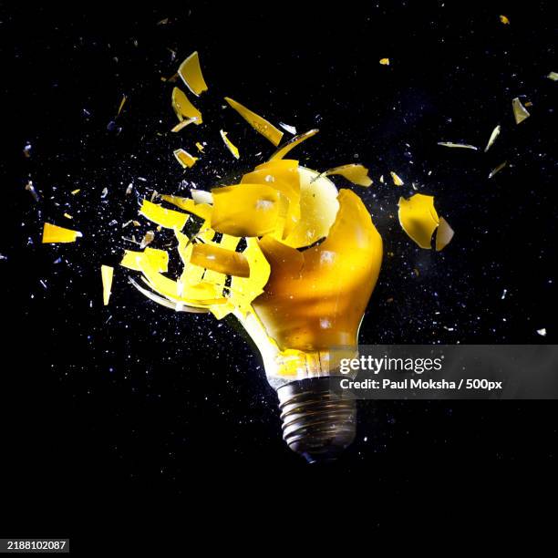 close up image of electric bulb explosion - exploding lightbulb stock pictures, royalty-free photos & images