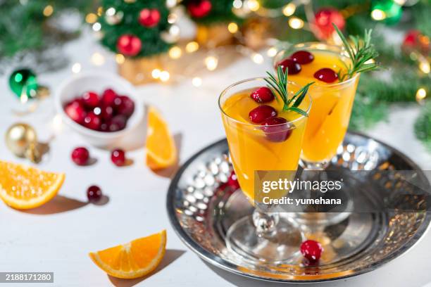 christmas orange cocktail with cranberry, rosemary and ice. alcoholic, non-alcoholic drink beverage - alcohol free stock pictures, royalty-free photos & images