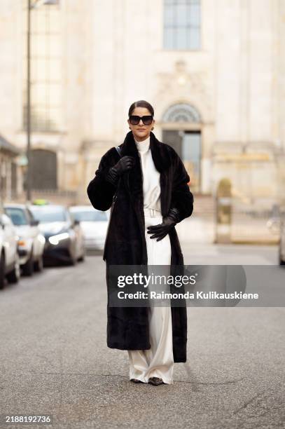 Gili Biegun wears silk cream long trousers and matching top with neck detail by Aeron, black leather square bag by Aeron, black sunglasses by Kaleos,...