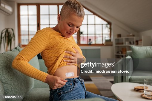 Female Applying HRT Patch for Hormonal Balance Female Applying HRT Patch for Hormonal Balance