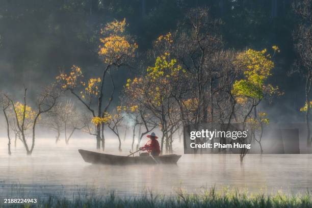 fisherman in tuyen lam lake - central highlands vietnam stock pictures, royalty-free photos & images