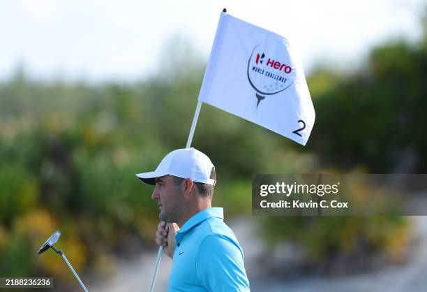 Scottie Scheffler of the United States removes the flagstick on the second green during a pro-am prior to the Hero World Challenge 2024 at Albany...