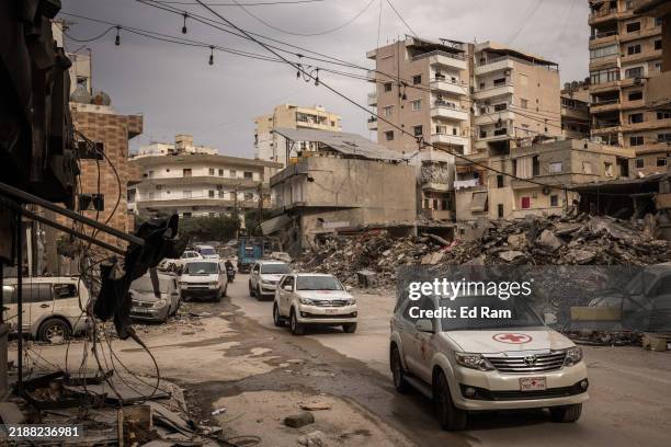 Cars from Lebanons Red Cross drive in convoy amid destruction from Israeli airstrikes on December 4, 2024 in Tyre, Lebanon. Israel and Hezbollah had...