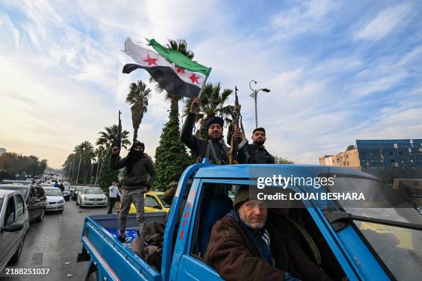 Anti-government fighters arrive at Umayyad Square in Damascus on December 8, 2024. Islamist-led rebels declared that they have taken Damascus in a...