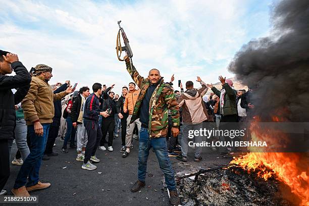 People celebrate at Umayyad Square in Damascus on December 8, 2024. Islamist-led rebels declared that they have taken Damascus in a lightning...