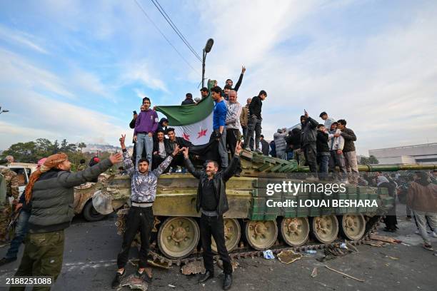 People celebrate with anti-government fighters at Umayyad Square in Damascus on December 8, 2024. Islamist-led rebels declared that they have taken...