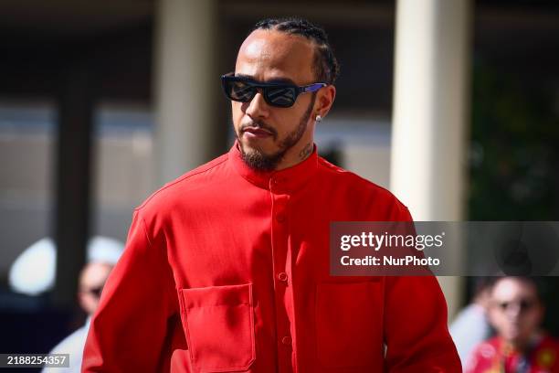 Lewis Hamilton of Mercedes dressed all in red arrives on the paddock on a race day of Formula 1 Abu Dhabi Grand Prix at Yas Marina Circuit on...