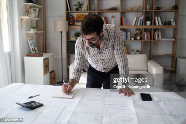 architect reviewing his drawings - computer aided design stock pictures, royalty-free photos & images