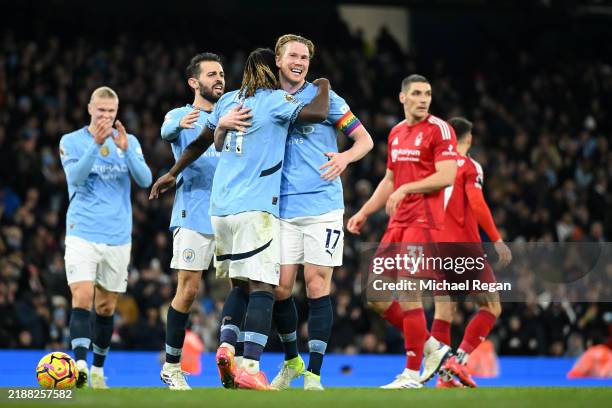 Kevin De Bruyne of Manchester City celebrates with teammate Jeremy Doku after scoring his team's second goal during the Premier League match between...
