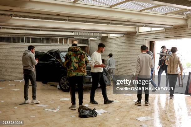 Syrians loot the Iranian embassy in the capital Damascus on December 8, 2024. Islamist-led rebels declared that they have taken Damascus in a...