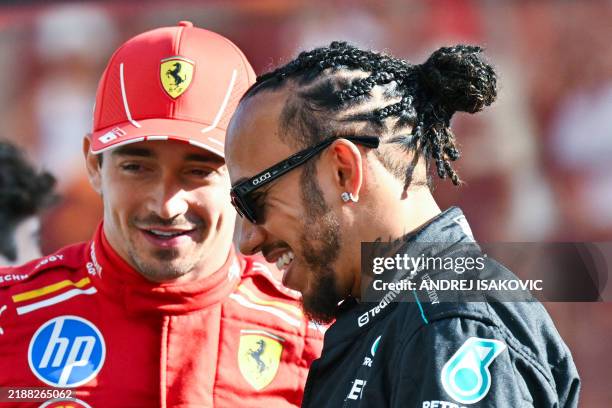 Mercedes' British driver Lewis Hamilton and Ferrari's Monegasque driver Charles Leclerc arrive for a group photo ahead of the Abu Dhabi Formula One...