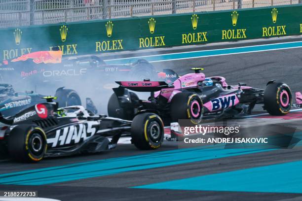 Red Bull Racing's Dutch driver Max Verstappen drives on after a collision with McLaren's Australian driver Oscar Piastri during the Abu Dhabi Formula...