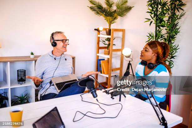 two people enjoying filming podcast at home broadcasting live on internet - microphone stand stock pictures, royalty-free photos & images