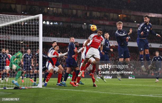 Jurrien Timber of Arsenal scores his team's first goal with a header as Andre Onana of Manchester United fails to make a save during the Premier...