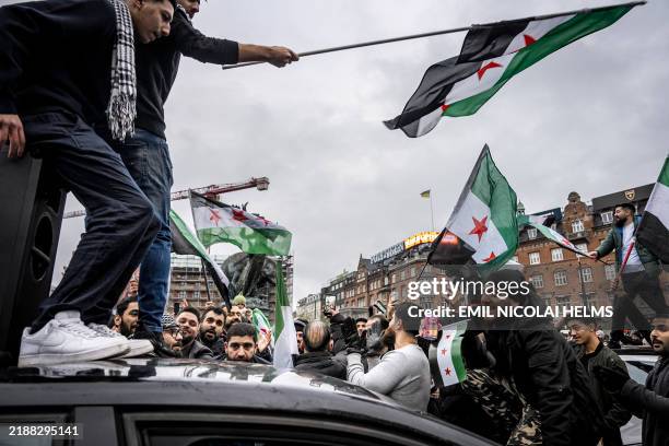 Members of the Syrian community wave Syrian flags on December 8, 2024 in Copenhagen, Denmark, as they rally to celebrate the end of Syrian dictator...