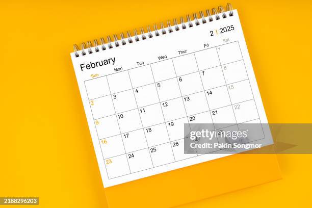 february 2025 desk calendar on yellow color background; empty space for your appointment text. - febrero fotografías e imágenes de stock