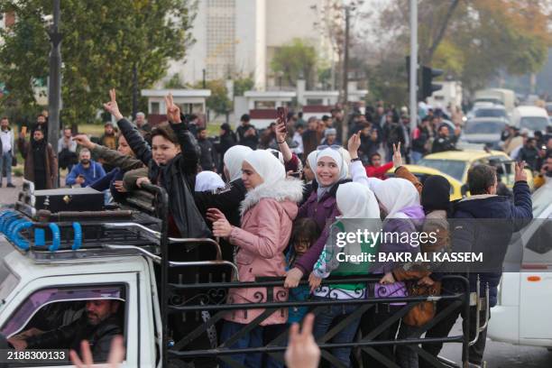 People celebrate at Umayyad Square in Damascus on December 8, 2024. Celebrations erupted around Syria and crowds ransacked President Bashar...