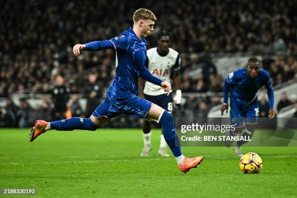 Chelsea's English midfielder Cole Palmer shoots a penalty kick and scores his team second goal during the English Premier League football match...