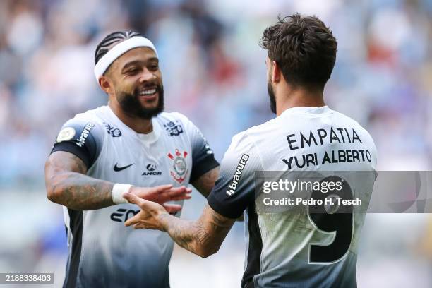 Yuri Alberto and Memphis Depay of Corinthians celebrate after scoring the first goal of his team during the match between Gremio and Corinthians as...