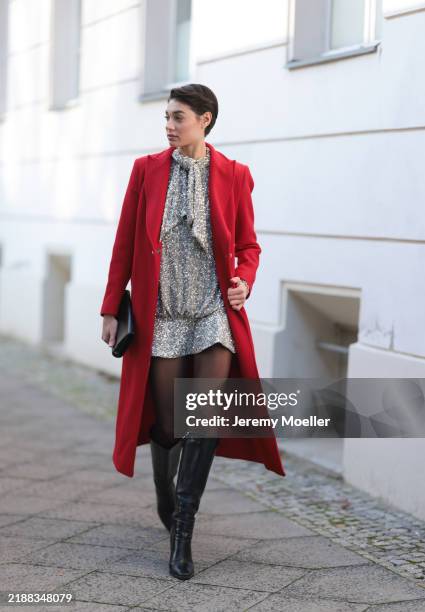Sarah Posch is seen wearing a calf-length red coat with peak lapels from Liu Jo; a sparkling silver New Year's Eve mini dress covered in sequins,...