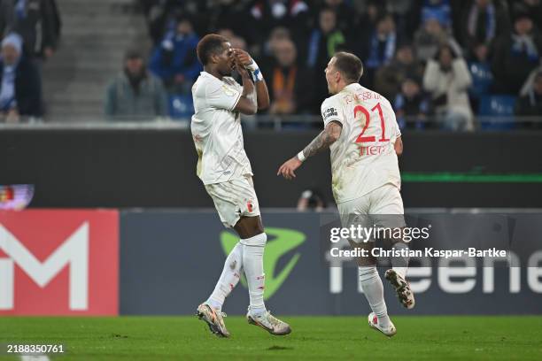 Samuel Essende of FC Augsburg celebrates after scoring his team’s first goal during the DFB Cup round of 16 match between Karlsruher SC and FC...