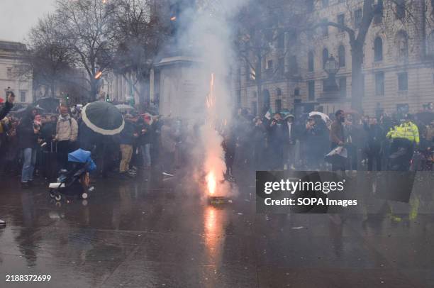 Fireworks are set off as members of the Syrian community and supporters gather in Trafalgar Square to celebrate the toppling of the Bashar al Assad...