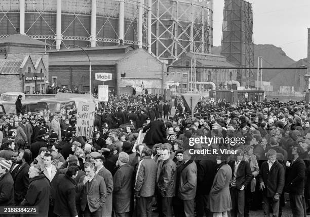 Crowd of miners and women picket the Saltley Gate fuel storage depot guarded by police during the national miners' strike, Birmingham, February 11th...
