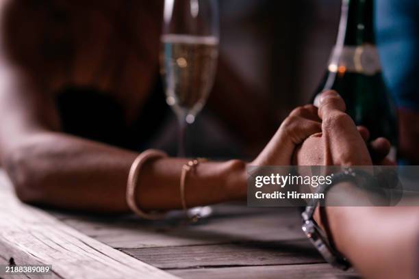 elegant evening with champagne and romantic hand-holding at a luxurious dining experience - charming stock pictures, royalty-free photos & images