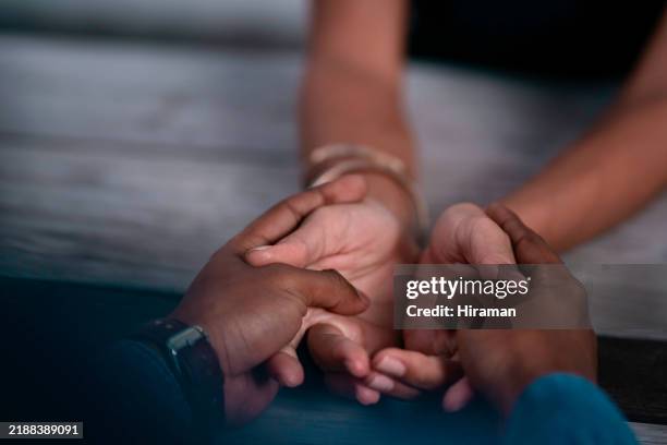 close-up of interracial couple holding hands at a dinner table, symbolizing love, connection, and togetherness, with a tender and warm atmosphere - hand patting stock pictures, royalty-free photos & images
