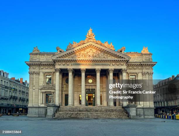 brussels "bourse" facade (stock exchange building) under the last rays of sunshine right before dusk in brussles, belgium - historic stock exchange building stock pictures, royalty-free photos & images