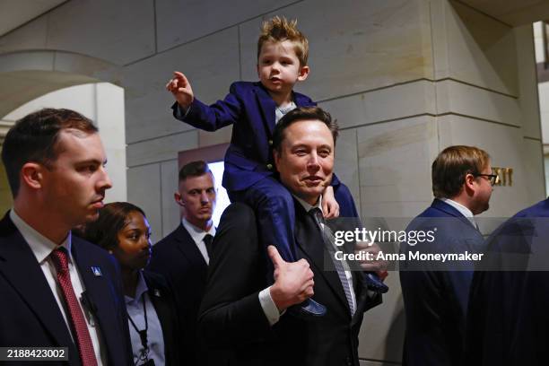 Tesla CEO Elon Musk, Co-Chair of the newly announced Department of Government Efficiency arrives with his son "X" on his shoulders at the U.S....