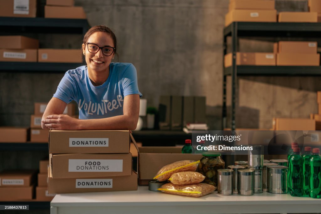 Volunteer sorting food donations in warehouse