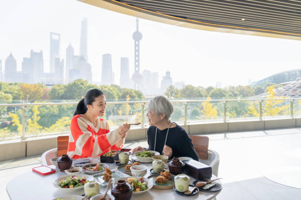 happy asian family having lunch together in outdoor restaurant. - shang hai restaurant stock pictures, royalty-free photos & images