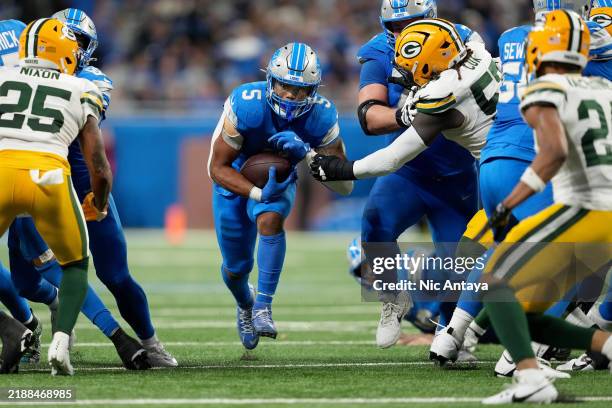 David Montgomery of the Detroit Lions runs the ball for a first down against the Green Bay Packers late in the fourth quarter of the game at Ford...