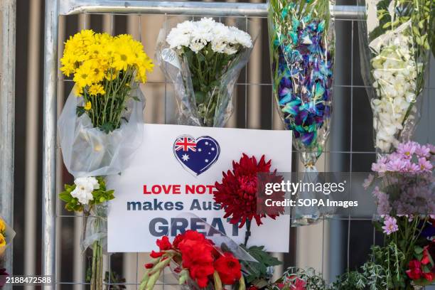 Signs and flowers in the temporary fence at the burnt Adass Israel Synagogue, after a rally calling for justice and unity in Melbourne. The Jewish...