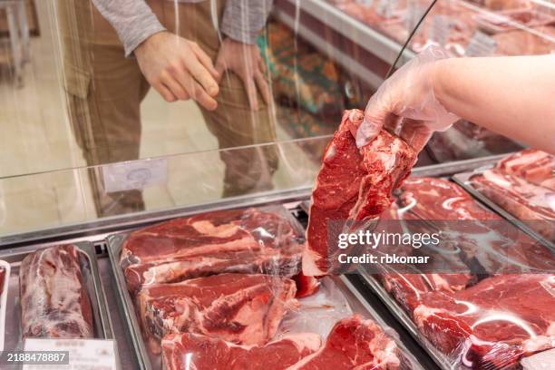 customer choosing meat at butcher counter - lamm fleisch stock-fotos und bilder