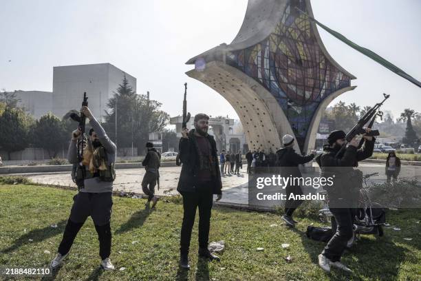 People celebrate the collapse of 61 years of Baath Party rule as they gather at Umayyad Square after armed groups, opposing Syria's Bashar al-Assad...